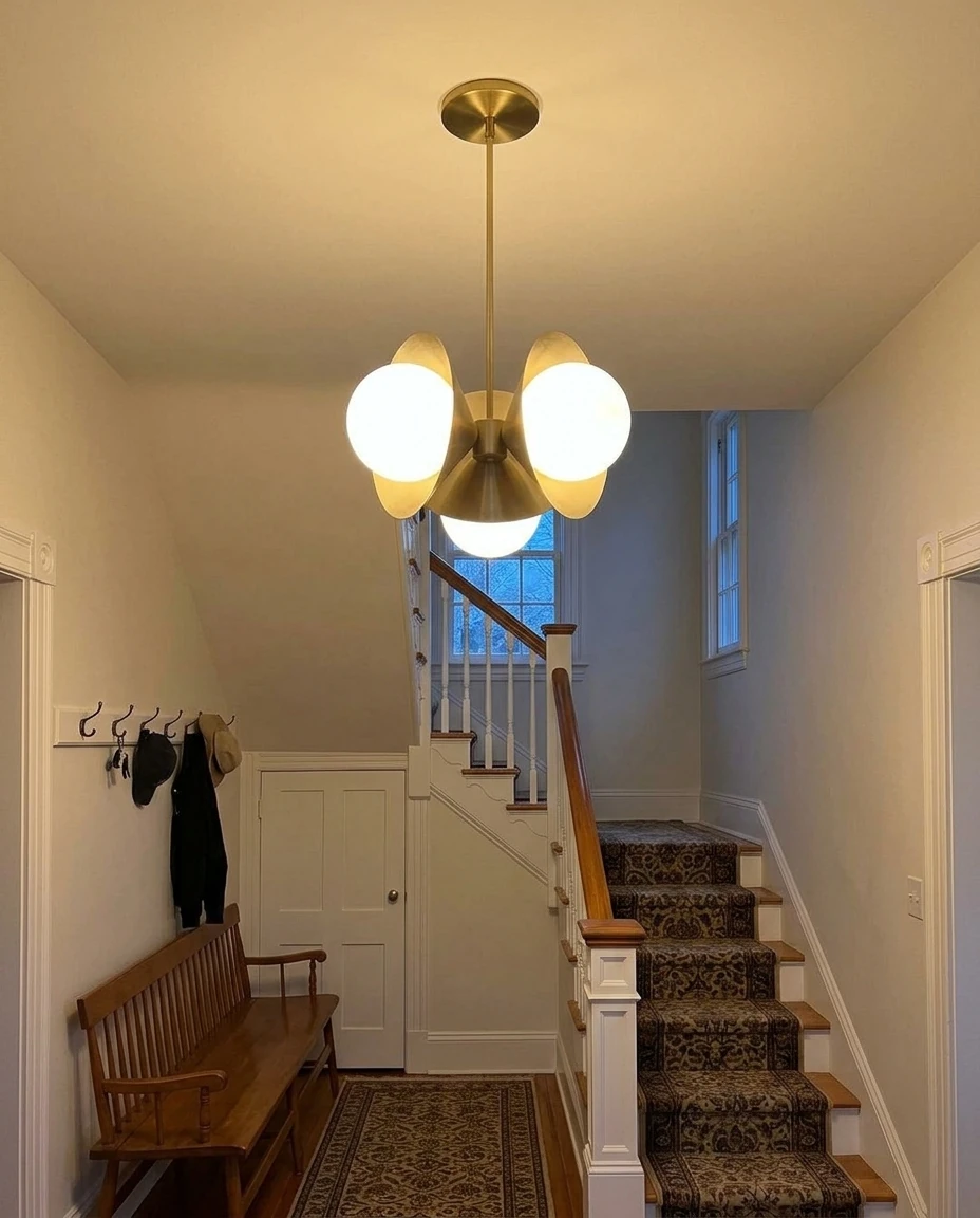 AI-generated brass cone chandelier photography: in the entryway