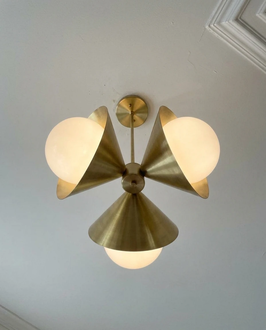 AI-generated brass cone chandelier photography: just installed