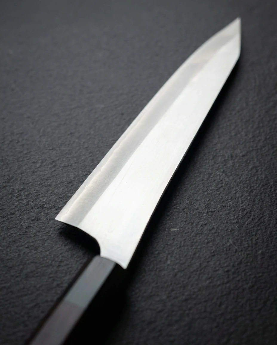 AI-generated ebony gyuto photography: blade from heel to tip