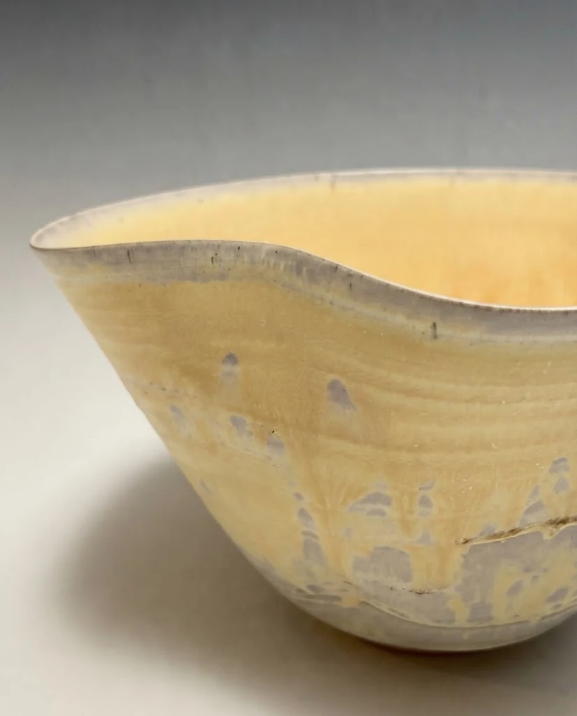 AI-generated ochre wave bowl photography: rim & glaze